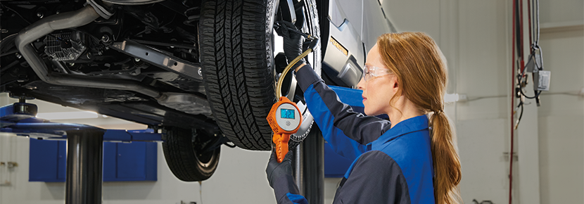 A Subaru technician checking tire pressure. | Fairway Subaru in Hazle Township PA
