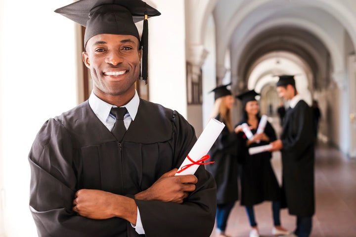 college graduate holding his diploma | Fairway Subaru in Hazle Township PA