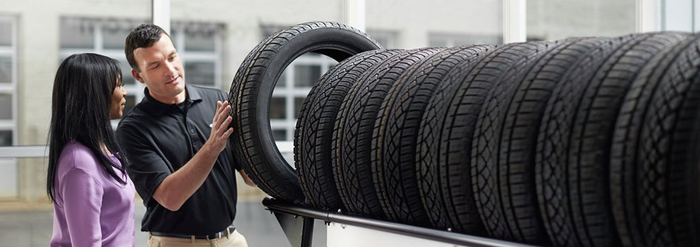 Subaru service representative showing customer a tire. | Fairway Subaru in Hazel Township PA