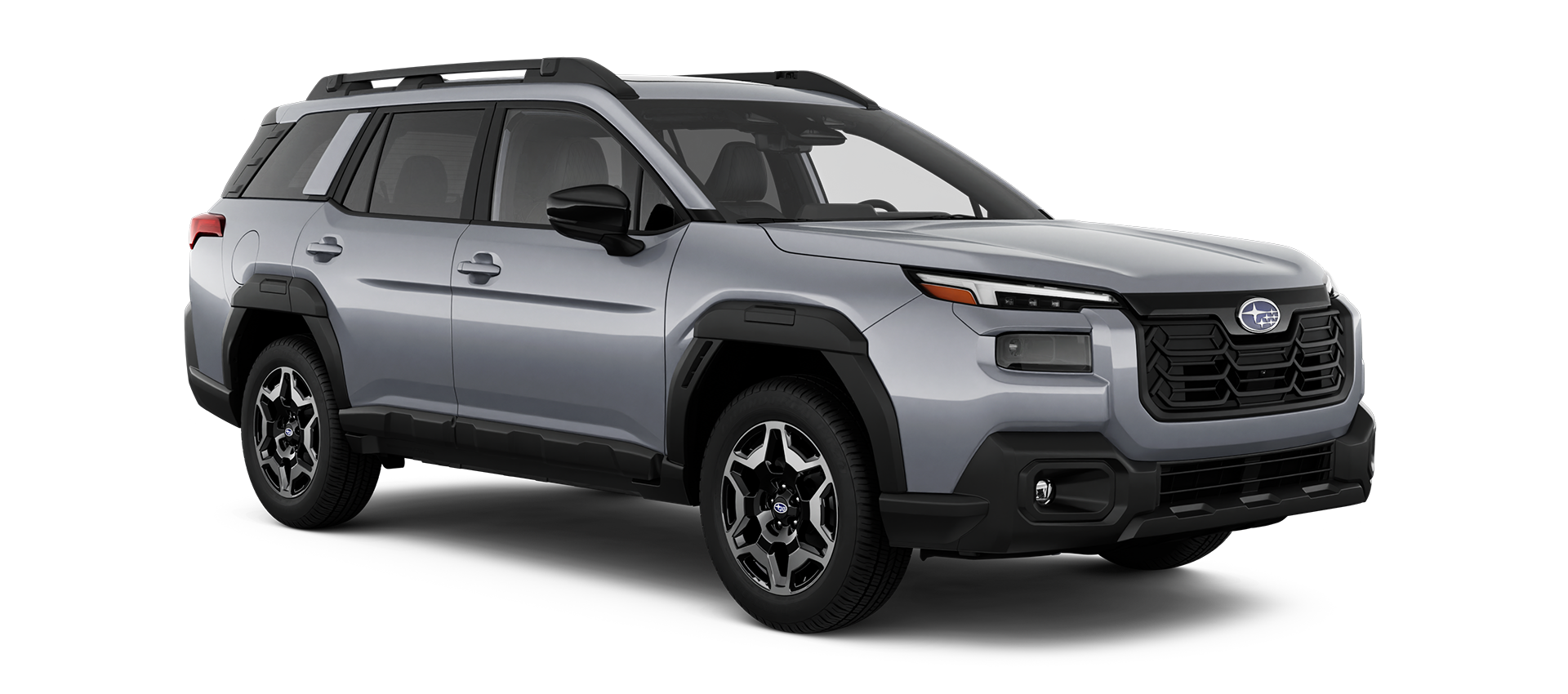 Silver Subaru utility vehicle with black roof rails, side mirrors, fenders, and lower body trim, angled slightly towards the right.